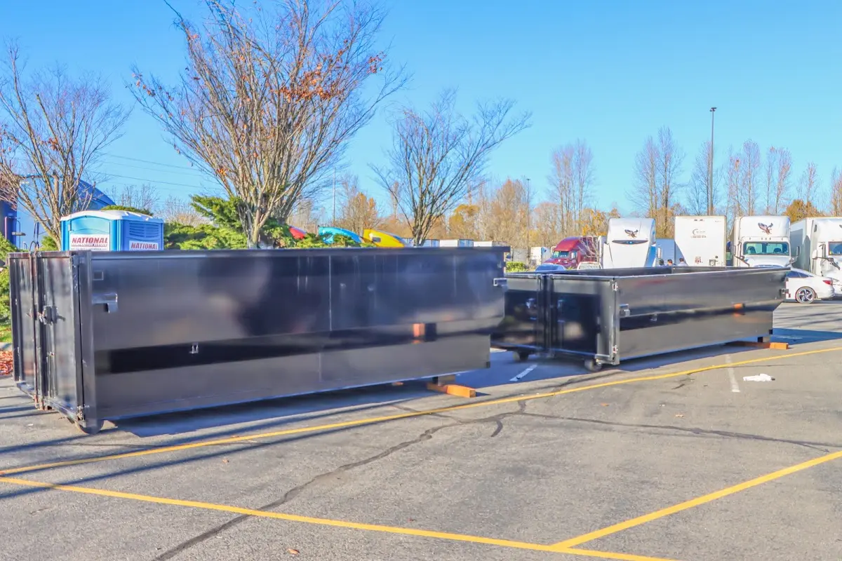 Professional dumpster rental service with roll-off container on residential driveway in Killingworth